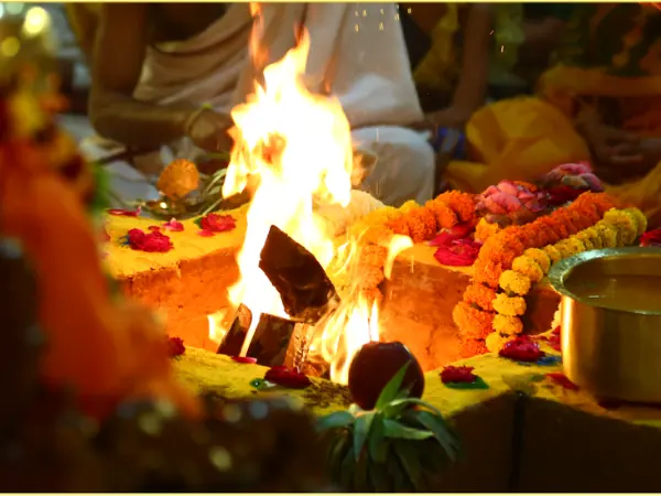 Sacred Narsimha Havan fire surrounded by marigolds and ritual offerings
