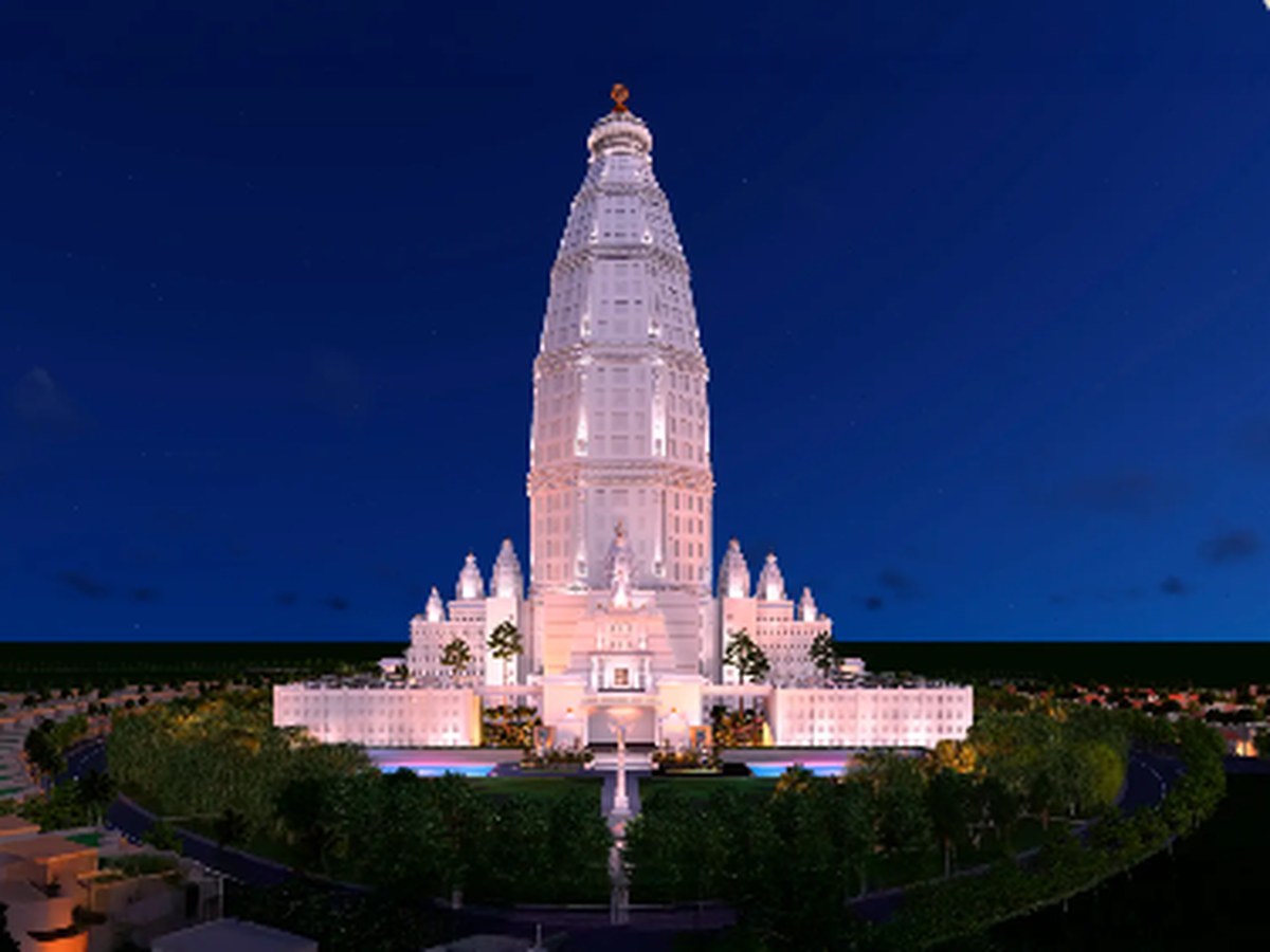 Vrindavan Chandrodaya Mandir illuminated against a deep blue evening sky